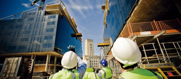 Three men in hard hats conduction a commercial building inspection in New Jersey