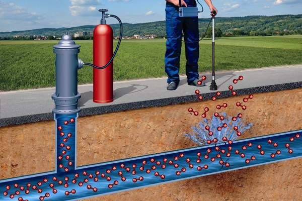 Image of man using device to detect a leak in an underground water pipeline